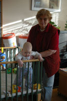 Caroline standing with help from grandma Emmy