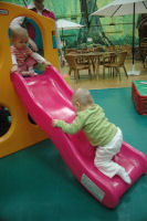 Caroline goes up the slide